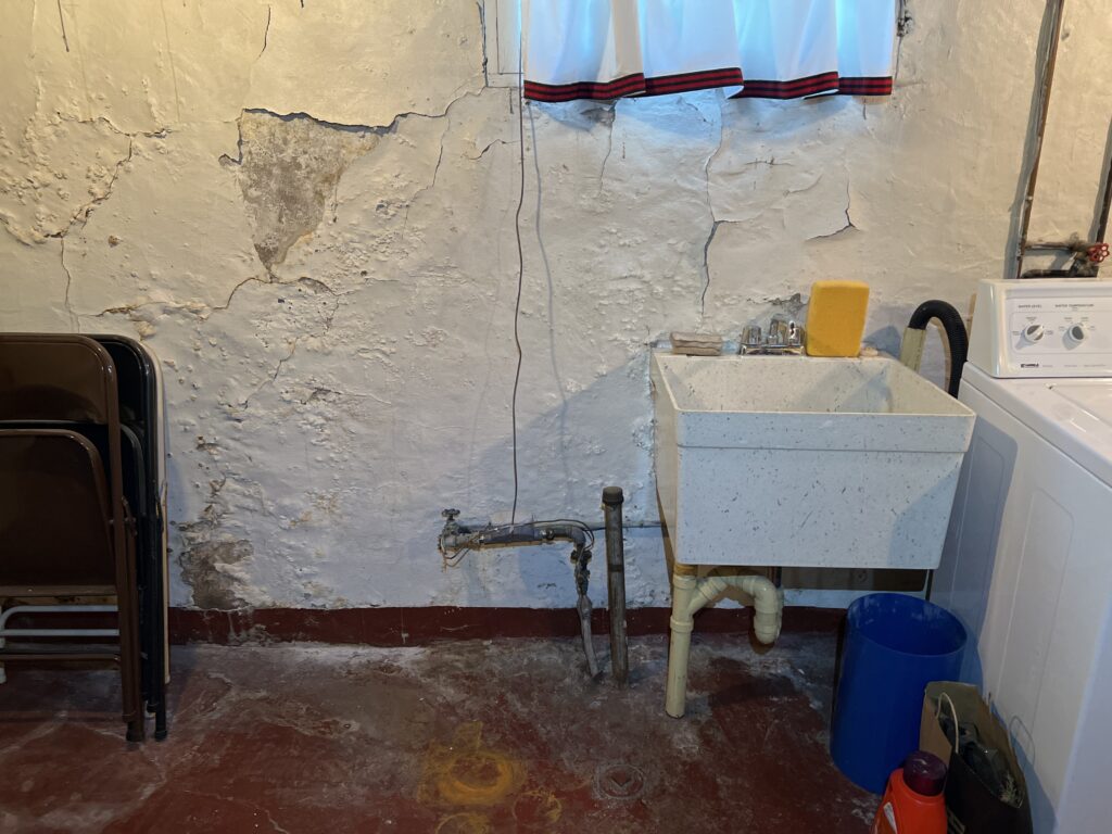 Old foundation with flaking paint, water stains, and efflorescence observed during a home inspection in Duluth MN